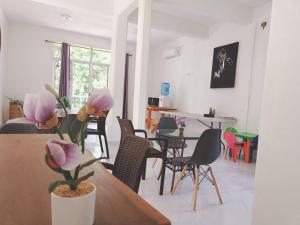 a living room with a table and chairs at HOKAB in Cenote Azul