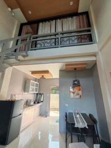 a kitchen with a dining table and a loft at ZK Loft Staycation Gensan in General Santos