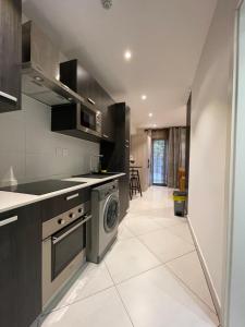 a kitchen with a washer and dryer at Executive Suites at The Lennox in Accra