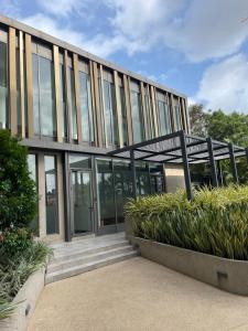 an office building with glass doors and some plants at Executive Suites at The Lennox in Accra