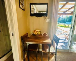 a dining room table with a bowl of fruit on it at Maple Woods B&B in Honeymoon Bay