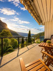a balcony with a table and chairs and a view at Stryn Panorama in Stryn