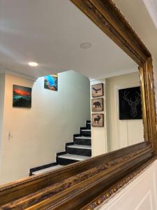 a mirror reflecting a staircase in a house at Boutique Princesa in Marbella