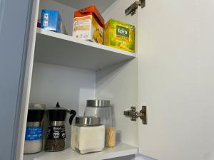 a kitchen pantry with food items on a shelf at Casa Mihuț in Cordău +8 photos