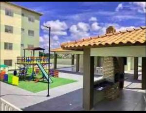 a playground with a slide and a playground at Day aconchego in Aracaju