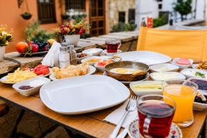 a wooden table with plates of food on it at Oldtown Patio in Antalya +27 photos