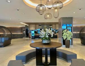 a lobby with a table with flowers on it at Shore 1 tower D Pasay City in Manila