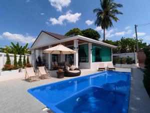 a swimming pool in front of a house at Sunset Pool Villa Ao Nang Krabi in Ao Nang Beach