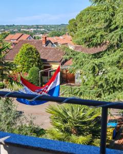a flag is flying in front of a house at Apartment with parking in Dajla