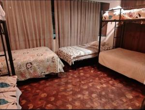 a room with two bunk beds and a carpet at Puruha Inn in Riobamba