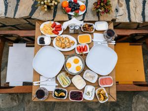 a table topped with plates of food and fruit at Oldtown Patio in Antalya