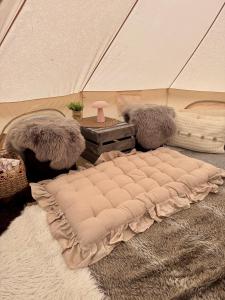 a mattress on a rug in a tent at Rampestreken Glamping in Åndalsnes