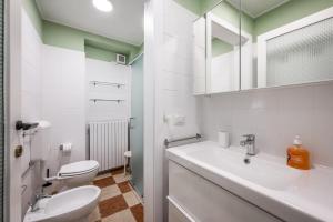 a bathroom with a sink and a toilet and a mirror at Casa Camilla - Arty Suite nel centro storico in Parma