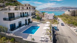 a villa with a swimming pool and a view of the ocean at Vila 2M in Sarandë