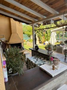 a patio with a table and an outdoor oven at Le petit studio in Calonge