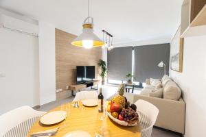 a dining room with a table with a bowl of fruit at NerjaPlus Terraza de Ladera Apartamento V11 in Nerja