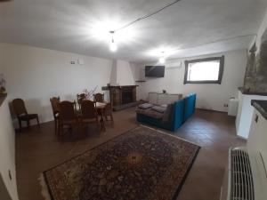 a living room with a couch and a table and chairs at Tenuta Mazzotti in Lago