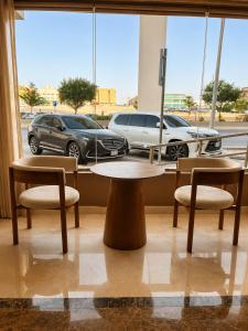 a table and chairs in a room with a view of a parking lot at Jwana in Riyadh +21 photos