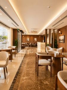 a lobby of a hotel with tables and chairs at Jwana in Riyadh