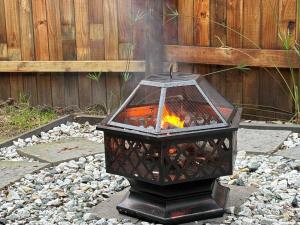 a fire in a bird cage in a garden at Raven in Stormsrivier