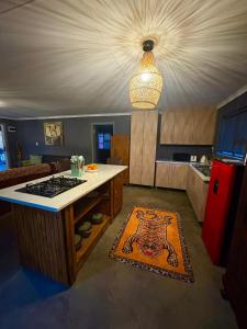 a kitchen with a stove and a counter top at Raven in Stormsrivier