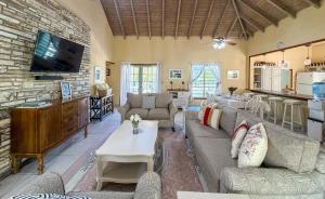 a living room with couches and a stone wall at Titi Vacation Homes in Cobbs Cross