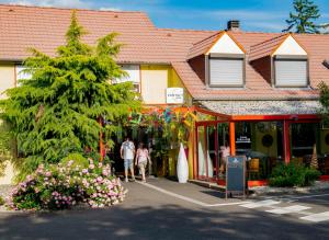 a group of people walking in front of a store at Hotel Arc-En-Ciel Colmar Contact Hotel in Colmar