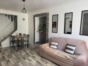 a living room with a couch and a table at Maison SYD saint-Junien in Saint-Junien