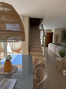 a living room with a dining table and chairs at Villa Ferrera Select A in Cala Ferrera