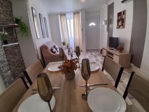 a dining room with a table and a living room at Maison SYD saint-Junien in Saint-Junien
