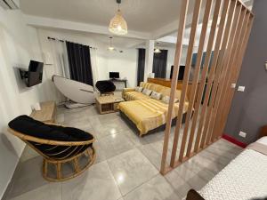 a living room with a bed and a couch at Makeda in Chiconi