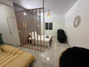 a room with a bed and a mirror in it at Makeda in Chiconi