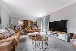 a living room with a large flat screen tv at 7 Bed in Coltishall oc-m31936 in Coltishall