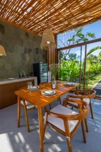 a wooden table and chairs in a kitchen at Juna Guest House in Uluwatu
