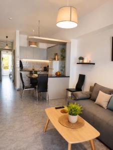 a living room with a couch and a table at Whisper wave in Haraki