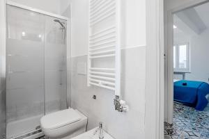 a white bathroom with a toilet and a shower at Le Finestre Sul Borgo 1 in Parma