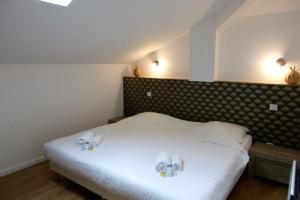 a bedroom with a white bed with two towels on it at Duplex House With Large Terrace And Garden in Moliets-et-Maa +17 photos