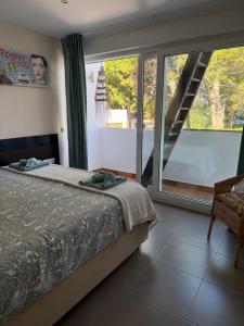a bedroom with a bed and a large window at Villa Ferrera Select A in Cala Ferrera +53 photos