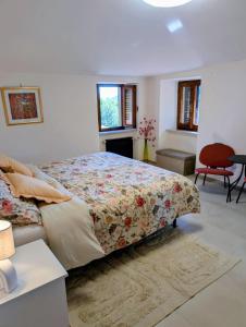 a bedroom with a bed and a table and a chair at All About You Montefiore in Casola in Lunigiana +34 photos