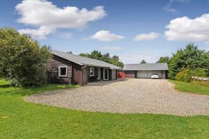 a house with a gravel driveway and a garage at C11253-Hemmet-Skuldbolvej-7-b in Hemmet