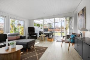 a living room with a couch and a table at 30392-Odder-Delfinvej-5 in Odder