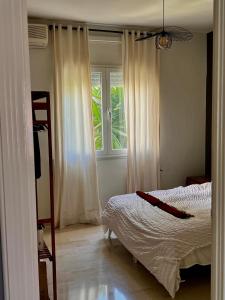 a bedroom with a bed and a window at la Soukra in Sukrah