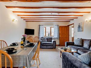 a living room with a table and a couch at 2 Bed in Dereham oc-92392 in Whissonsett