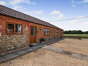 a brick house with a stone wall at 2 Bed in Dereham oc-92392 in Whissonsett