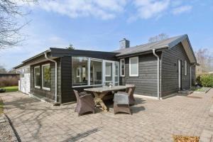 a small house with a picnic table in front of it at 30392-Odder-Delfinvej-5 in Odder