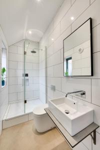 a white bathroom with a sink and a shower at 7 Bed in Holme-on-Spalding-Moor oc-vy216 in Holme upon Spalding Moor +44 photos