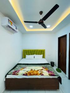 a bedroom with a bed with a ceiling fan at Hotel Lucifer by Evening Star in Bathinda