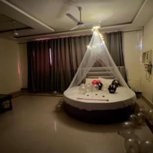 a room with a table with a tent and balloons at Hotel Lucifer by Evening Star in Bathinda