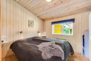 a bedroom with a bed with a furry blanket on it at C11645-Hemmet-Kosigvaenget-100 in Hemmet