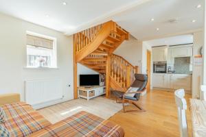 a living room with a staircase and a couch and a chair at 2 Bed in Newark oc-91051 in Caunton